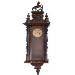 A late Victorian stained walnut wall clock, surmounted by a prancing horse with mask and urn finial,