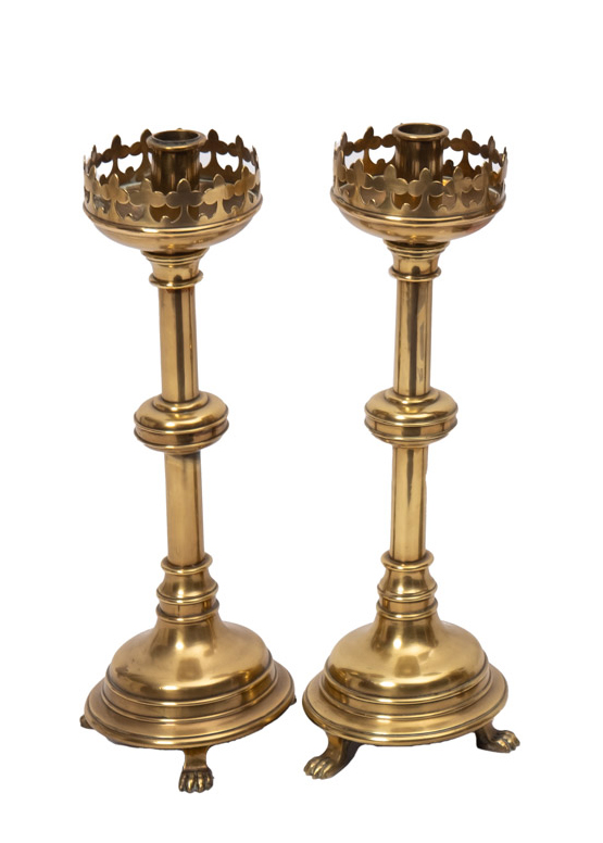 A pair of Victorian brass 'Gothic' candlesticks with pierced sconces,