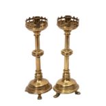 A pair of Victorian brass 'Gothic' candlesticks with pierced sconces,