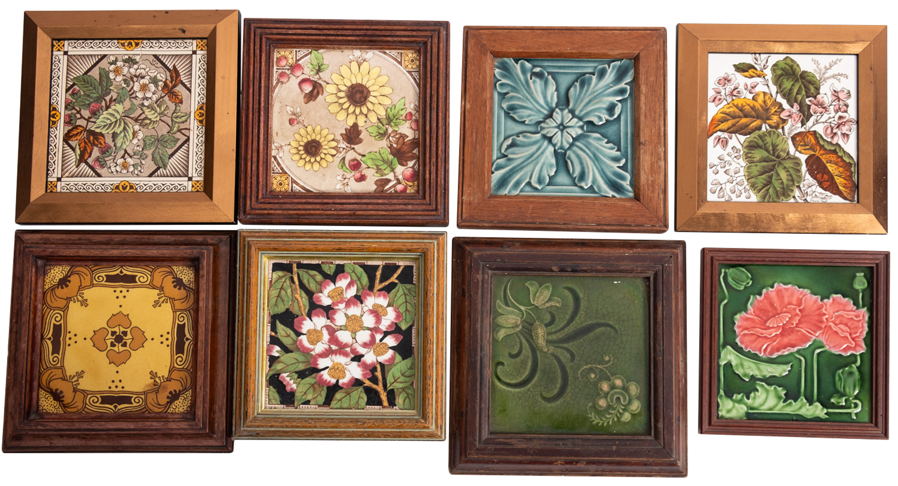 A collection of eight Staffordshire pottery glazed tiles with floral foliate decoration,