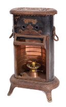 An Edwardian 'Petrolux' iron and cast metal room heater of oval outline,