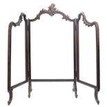 A 19th century French ebonised three-fold screen with floral carved show frame raised on scroll