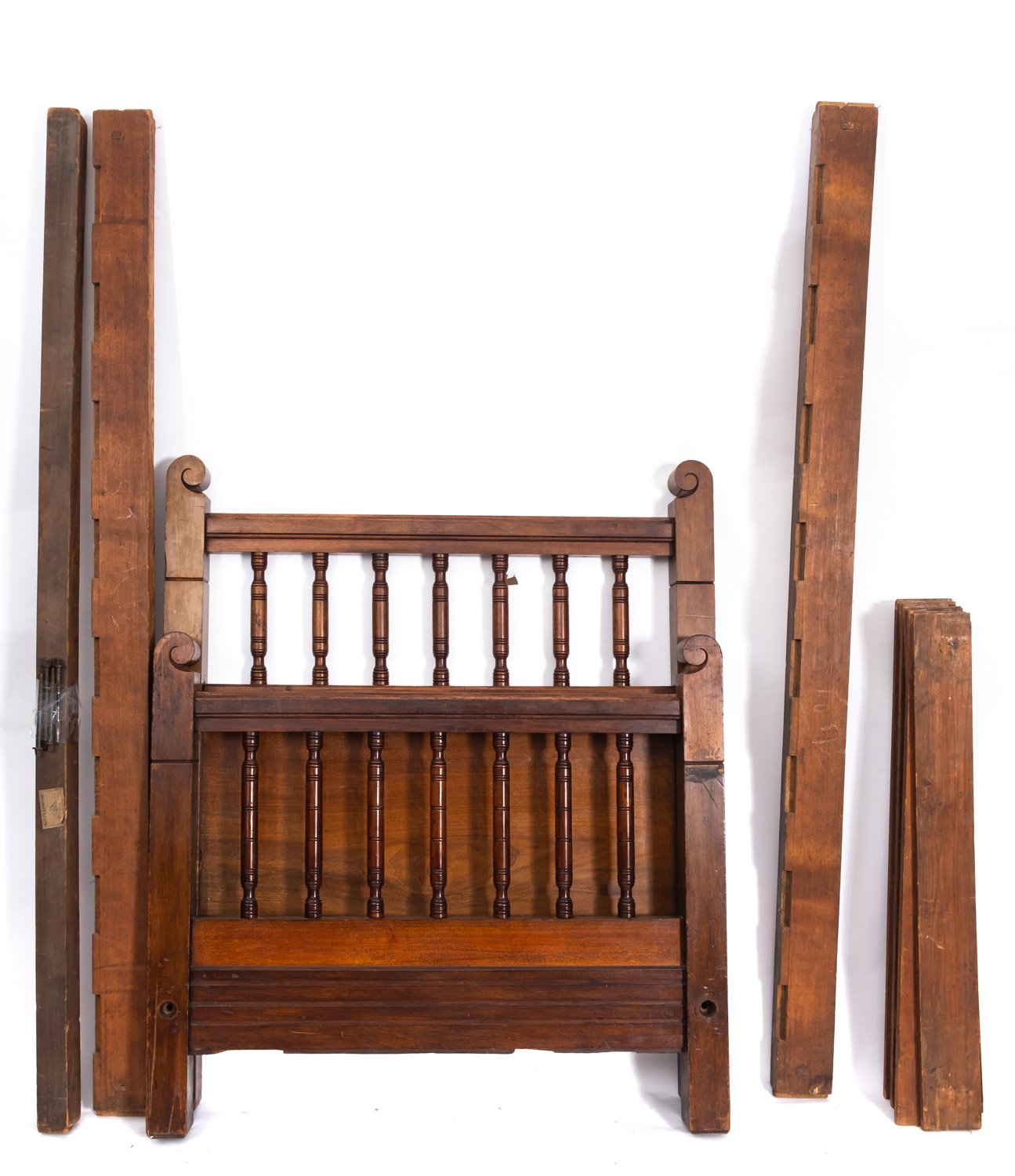 An Edwardian walnut single bed, early 20th Century, with turned uprights to head and footboard,