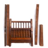 An Edwardian walnut single bed, early 20th Century, with turned uprights to head and footboard,