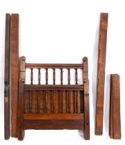 An Edwardian walnut single bed, early 20th Century, with turned uprights to head and footboard,