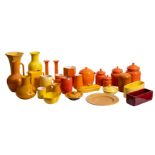 A collection of brightly coloured orange and yellow glazed ceramicwares including a pair of