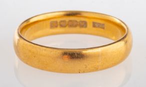 A 22ct yellow gold wedding band, UK hall