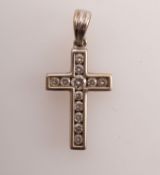 A diamond set cross in 18ct white gold,