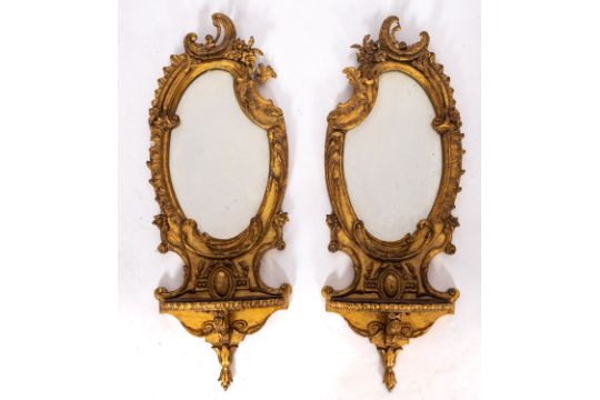 A pair of gilt composition mirrored wall brackets, in Louis XV taste,