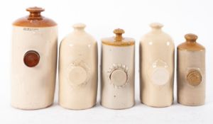A group of five various stoneware hot water bottles