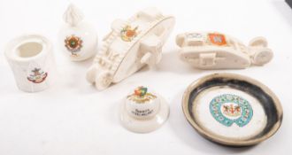 Two crested ware WWI tanks, 'HMS Donner -Blitzen' and one other together with a grenade, a helmet,