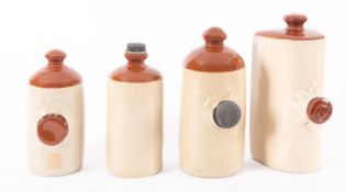 A group of four various stoneware hot water bottles