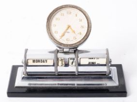 An early 20th century nickel plated perpetual desk calendar having eight day clock over cylindrical