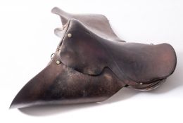 Three brown leather saddles