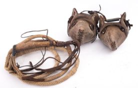A pair of brown leather of Gaucho stirrups. together with a rope work bridle and whip.