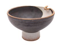 A stoneware footed bowl, the rim modelled with a gilt serpent, the body with stencilled decoration,