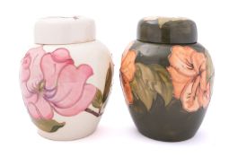 Two Moorcroft pottery jars and covers,