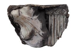 A raku fired stoneware sculpture, of a female torso before a fluted pilaster,