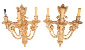 A set of four carved and giltwood three light wall appliques in Louis XVI style,