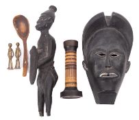 A small collection of ethnographica, 20th century; including an African carved ebony mask,