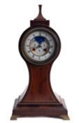 A balloon shaped late-Victorian mahogany moonphase mantel clock