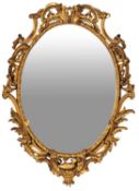 A carved and giltwood framed oval wall mirror in Louis XV taste,