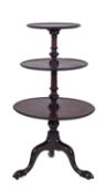 A George III mahogany circular three tier graduated dumb waiter,