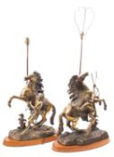 A pair of Continental patinated bronze models of the Marly Horses,