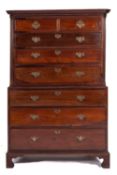 A George III mahogany chest on chest, the upper part with a moulded cornice and cut corners,