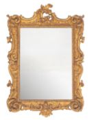 A carved and giltwood framed wall mirror in Rococo taste,