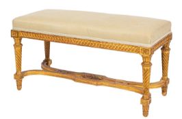 A carved giltwood and upholstered long stool, in Louis XVI style,