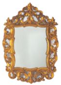 A carved and giltwood framed wall mirror in 18th century style, probably Spanish,