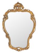 A carved and giltwood framed wall mirror in Louis XV taste, 20th century; of cartouche form,