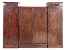 A Regency mahogany and inlaid combination wardrobe, in three sections, with ebonised mouldings,
