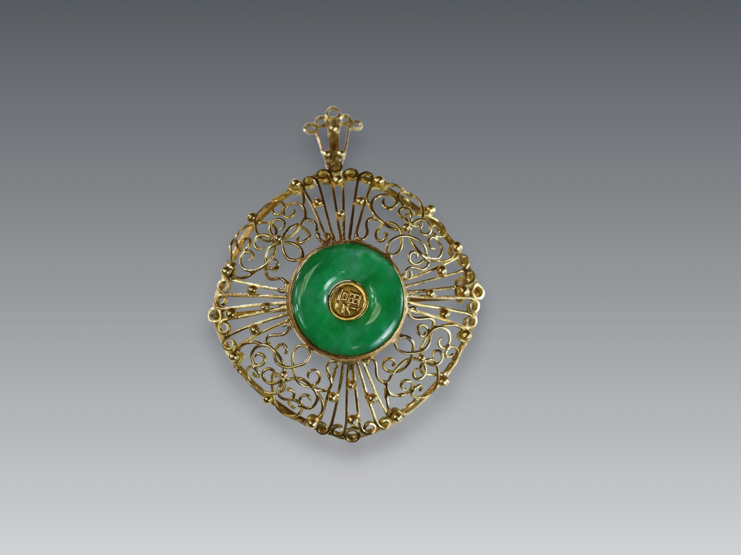 A 1960s Apple Green Jadeite Bi Disc and 18 ct Yellow Gold Pendant/Brooch, in entwined wirework