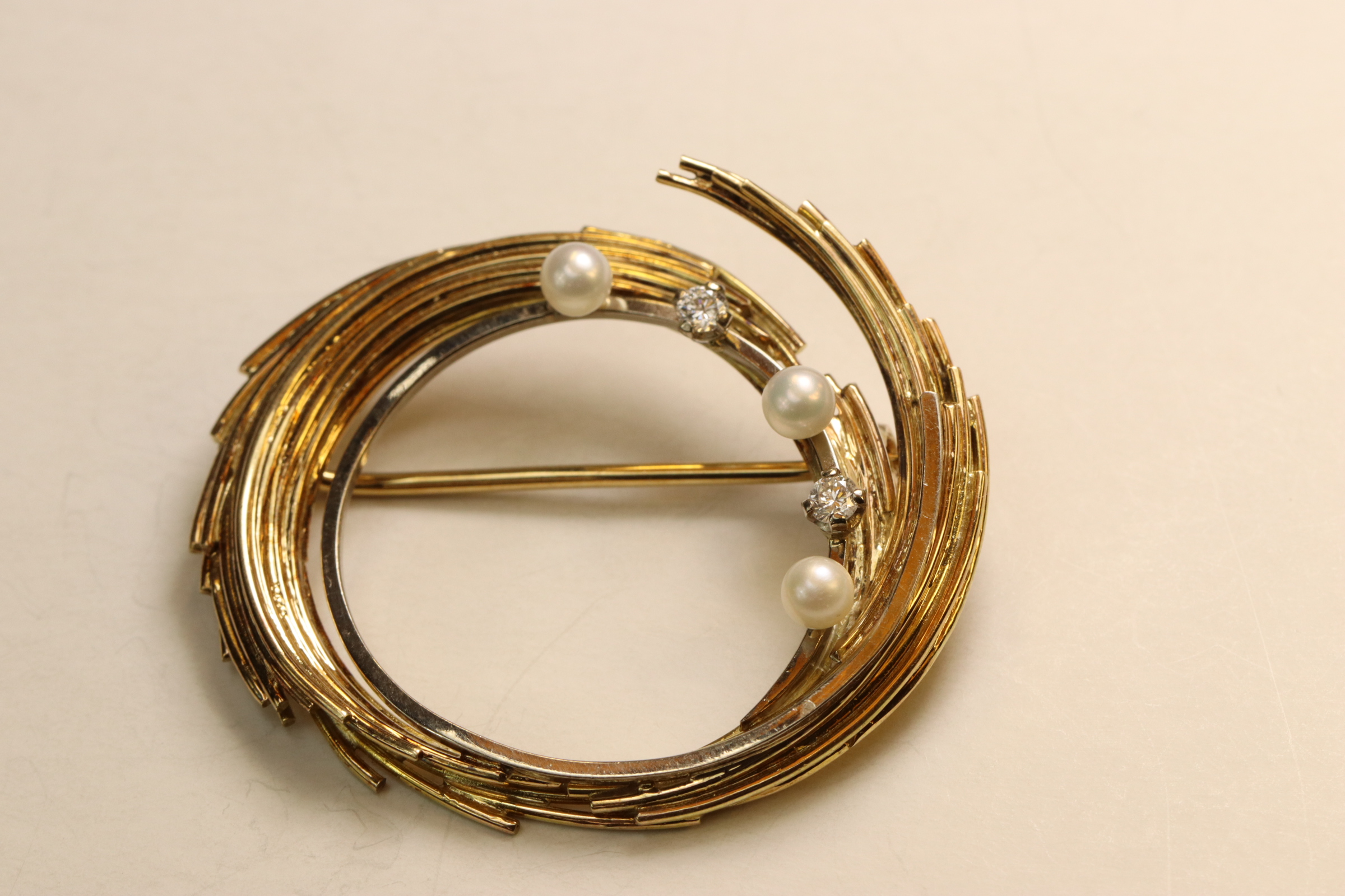 A Diamond, 18 ct Gold and Pearl Brooch, circa 1970, Of wire work swirl design set with small - Image 2 of 4