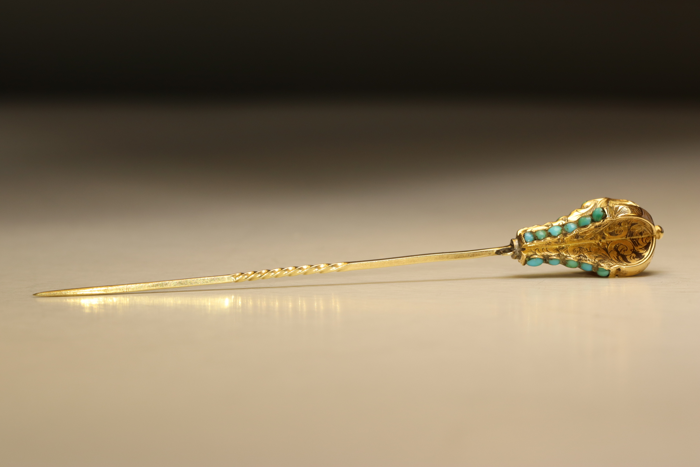 An Antique 18 ct Yellow Gold and Turquoise Stick Pin, circa 1880 The head finely engraved with