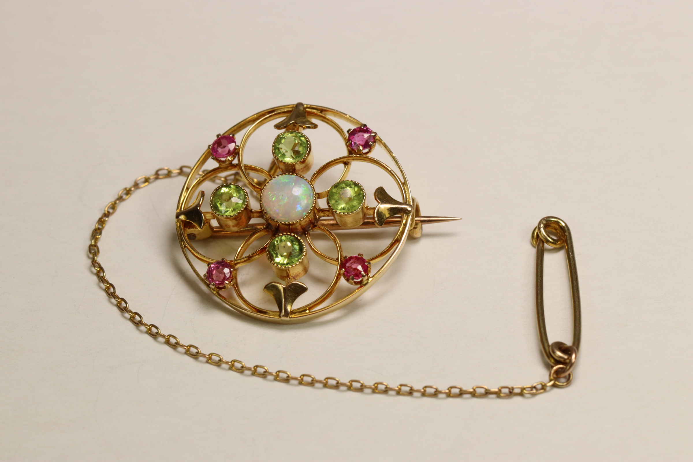 An Antique Opal, Peridot and Pink Stone Target Brooch, circa 1910 Millegraine set central opal, - Image 2 of 7