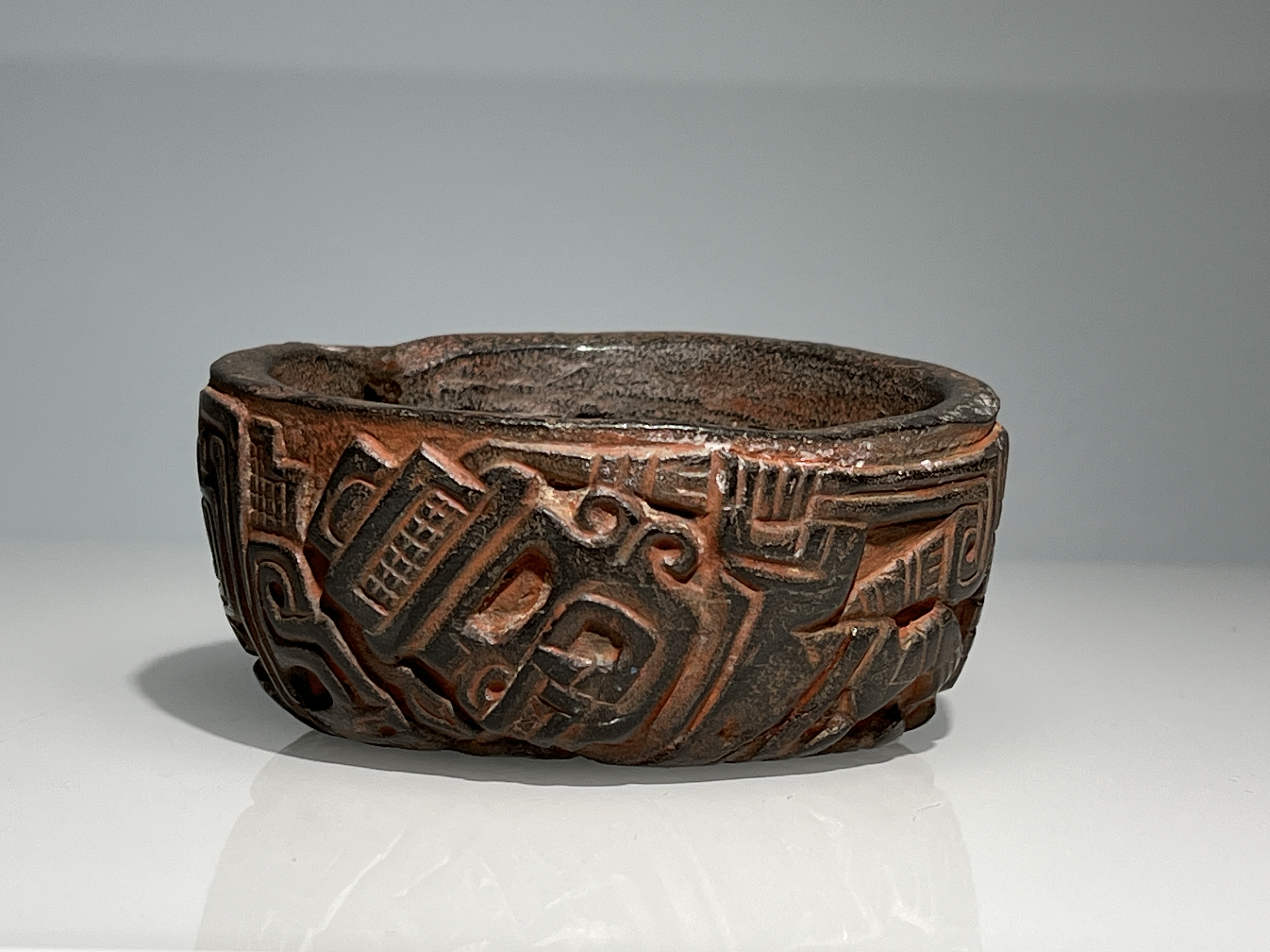 A Chavin Culture Stone Vessel with Mythical Figures. Peru ca. 900-250 BC.The carved and polished