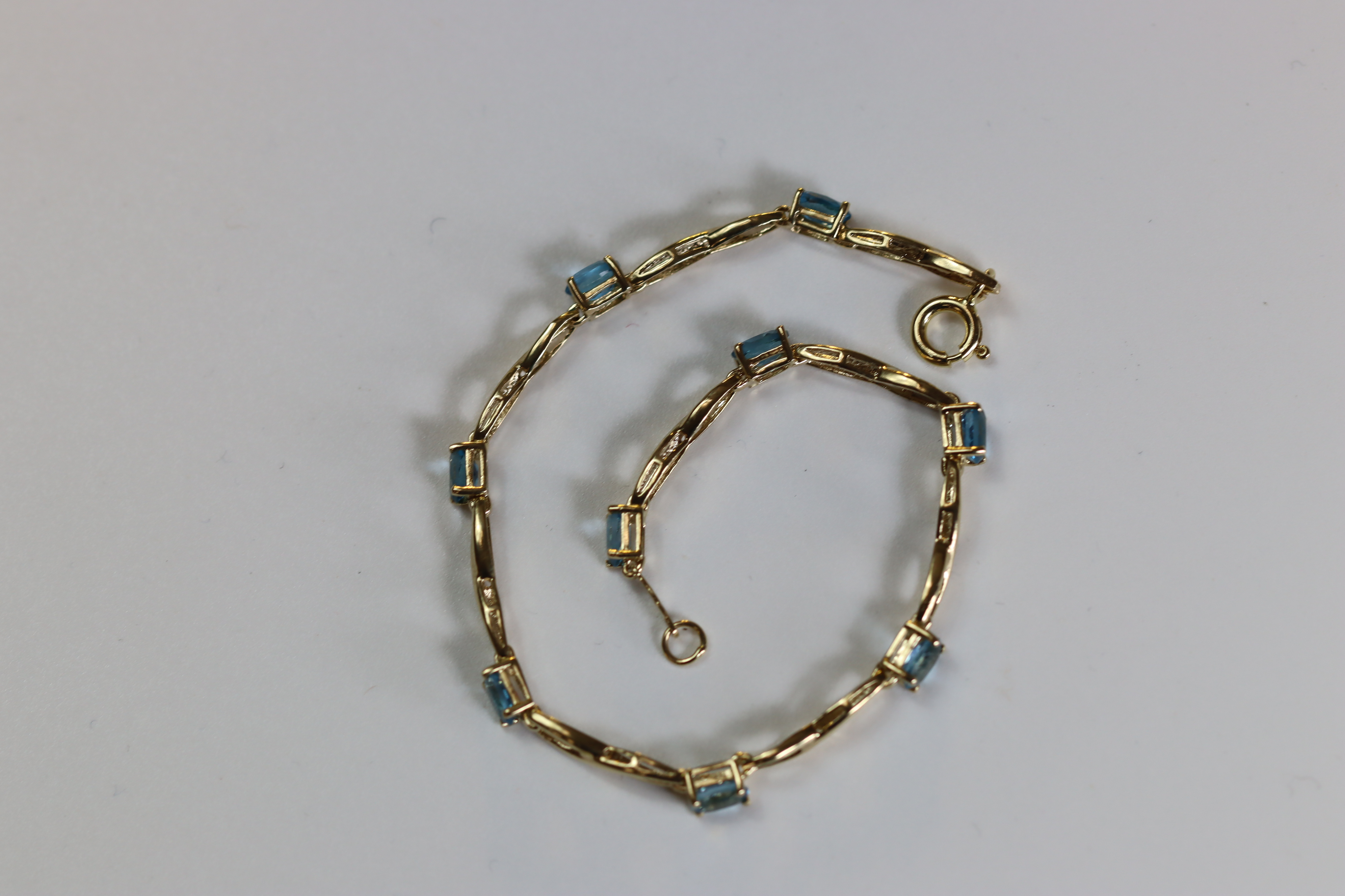 A Blue Topaz and Yellow Metal Line Bracelet A Blue Topaz and Yellow Metal Line Bracelet, set with - Image 8 of 8