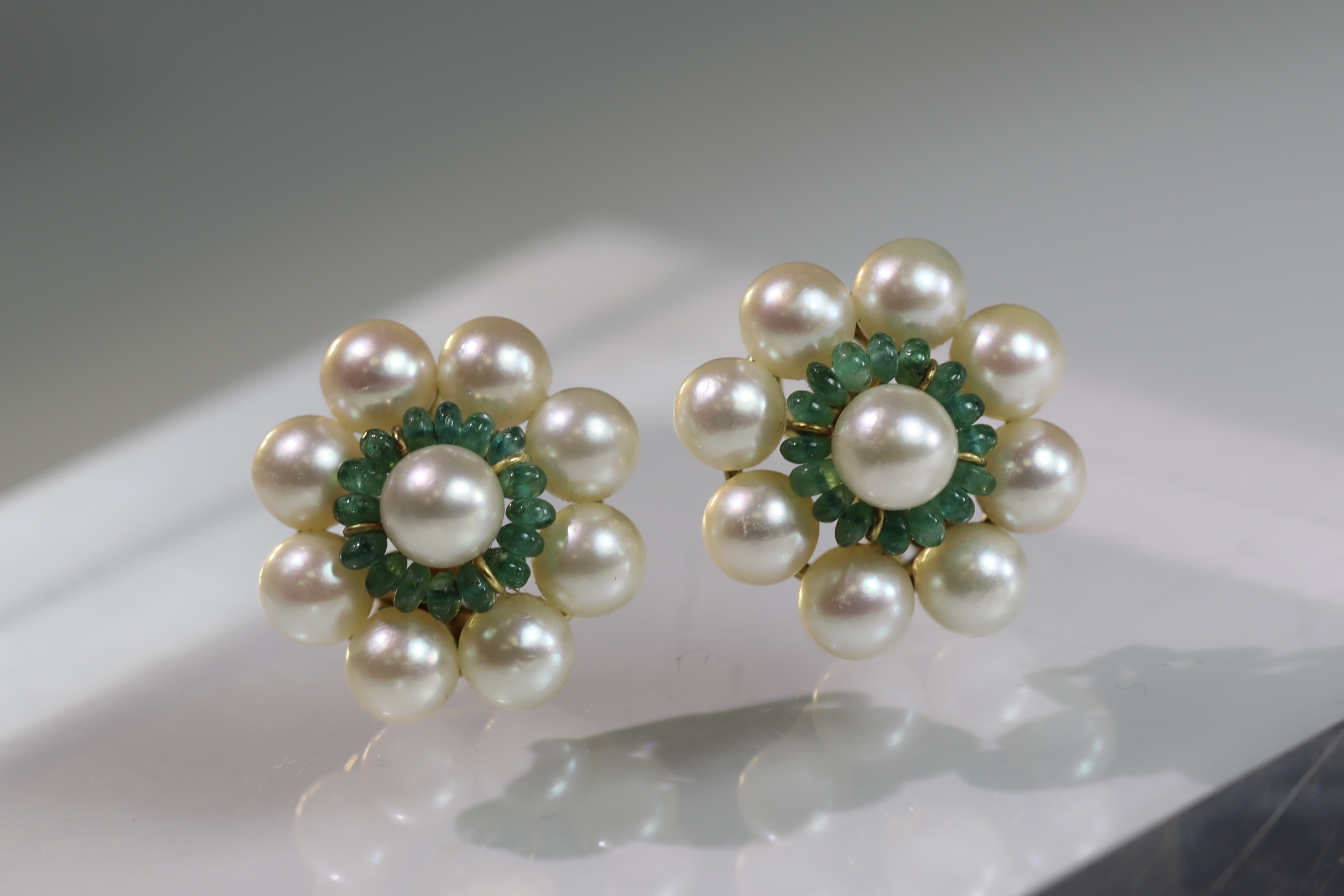 A Pair of Cultured Pearl and Emerald Circular Cluster Earrings each set with a 7.9mm cultured