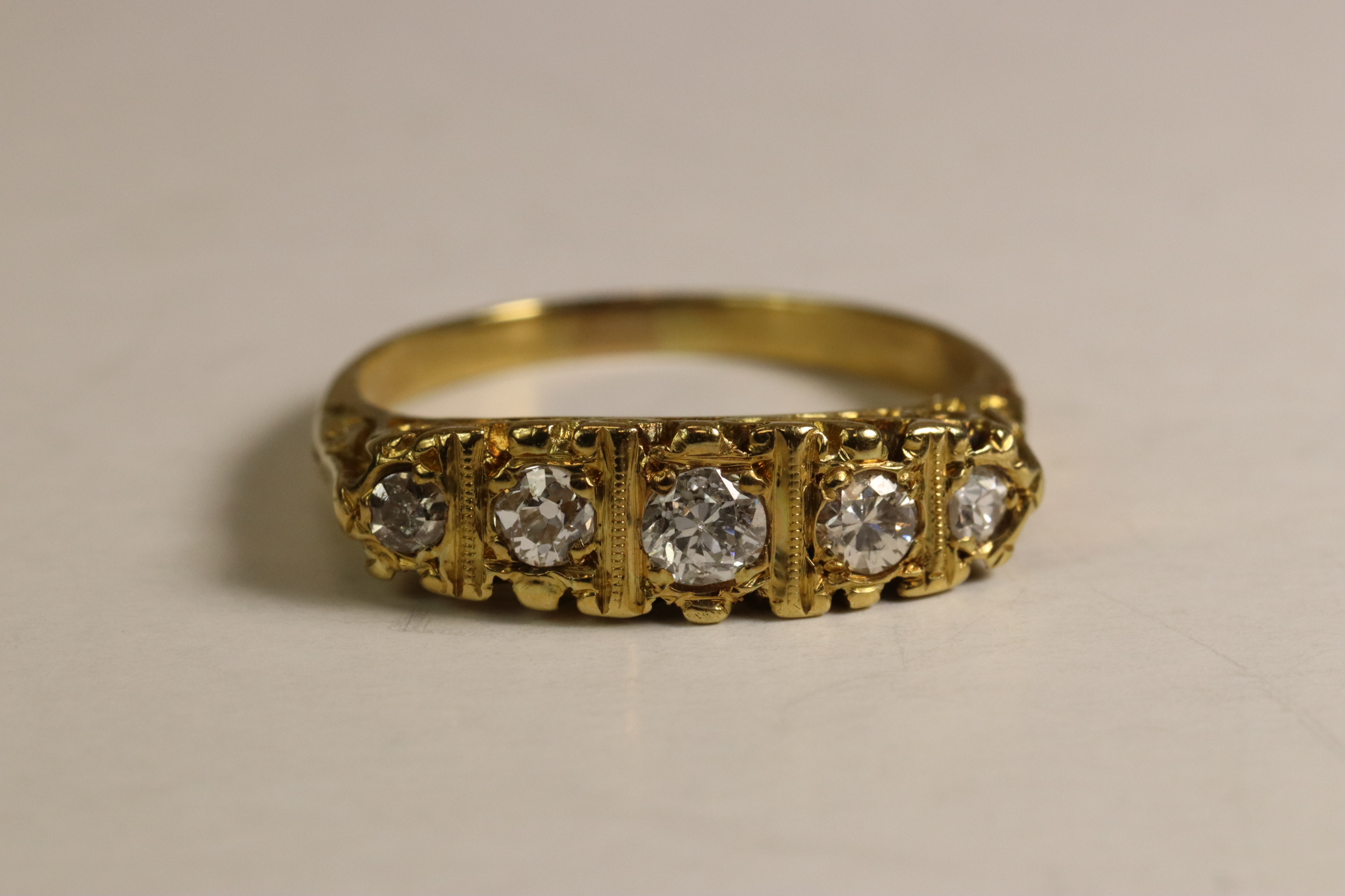 A Diamond Five Stone Ring, The graduated old brilliant cut diamonds mounted in a carved 18 ct - Image 2 of 6