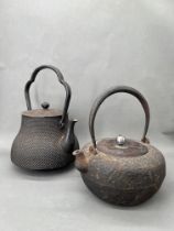 A Pair of Tetsubin Kettles, Japan, 19th Century.A pair of iron kettles (tetsubin) H:21cm, 25cm;