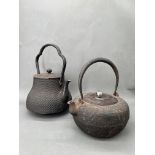 A Pair of Tetsubin Kettles, Japan, 19th Century.A pair of iron kettles (tetsubin) H:21cm, 25cm;
