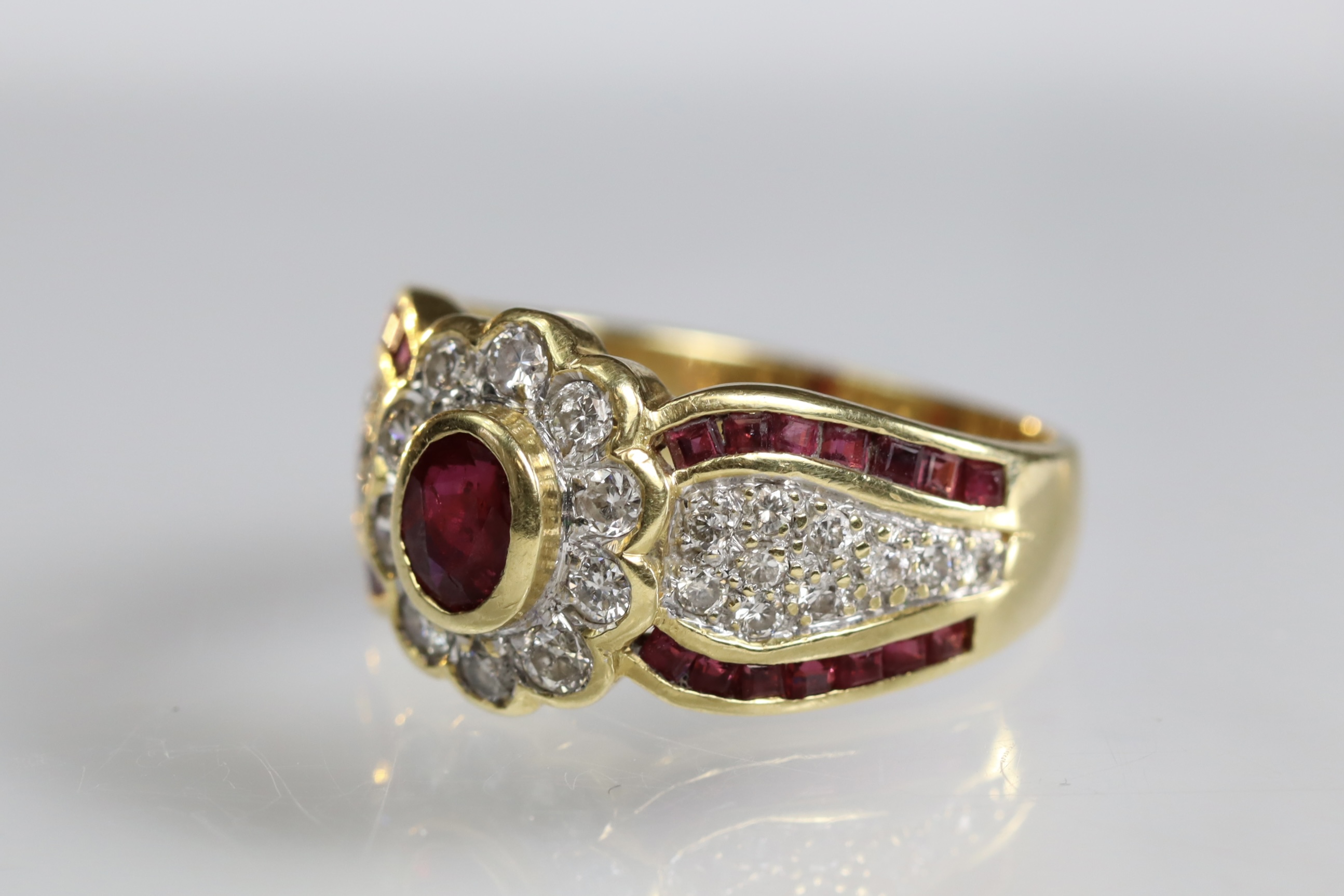 A contemporary 18 carat Yellow Gold, Ruby and Diamond Dress Ring,the oval shaped ruby central - Image 3 of 14