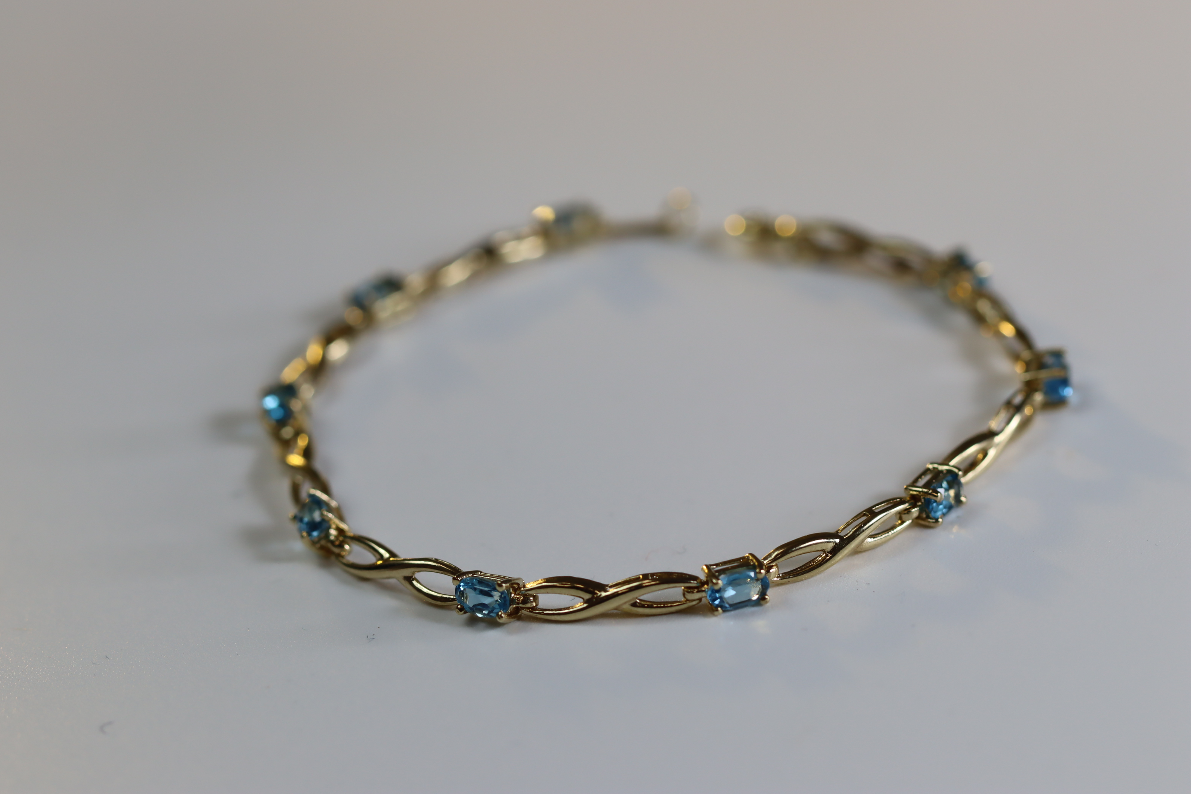 A Blue Topaz and Yellow Metal Line Bracelet A Blue Topaz and Yellow Metal Line Bracelet, set with - Image 4 of 8