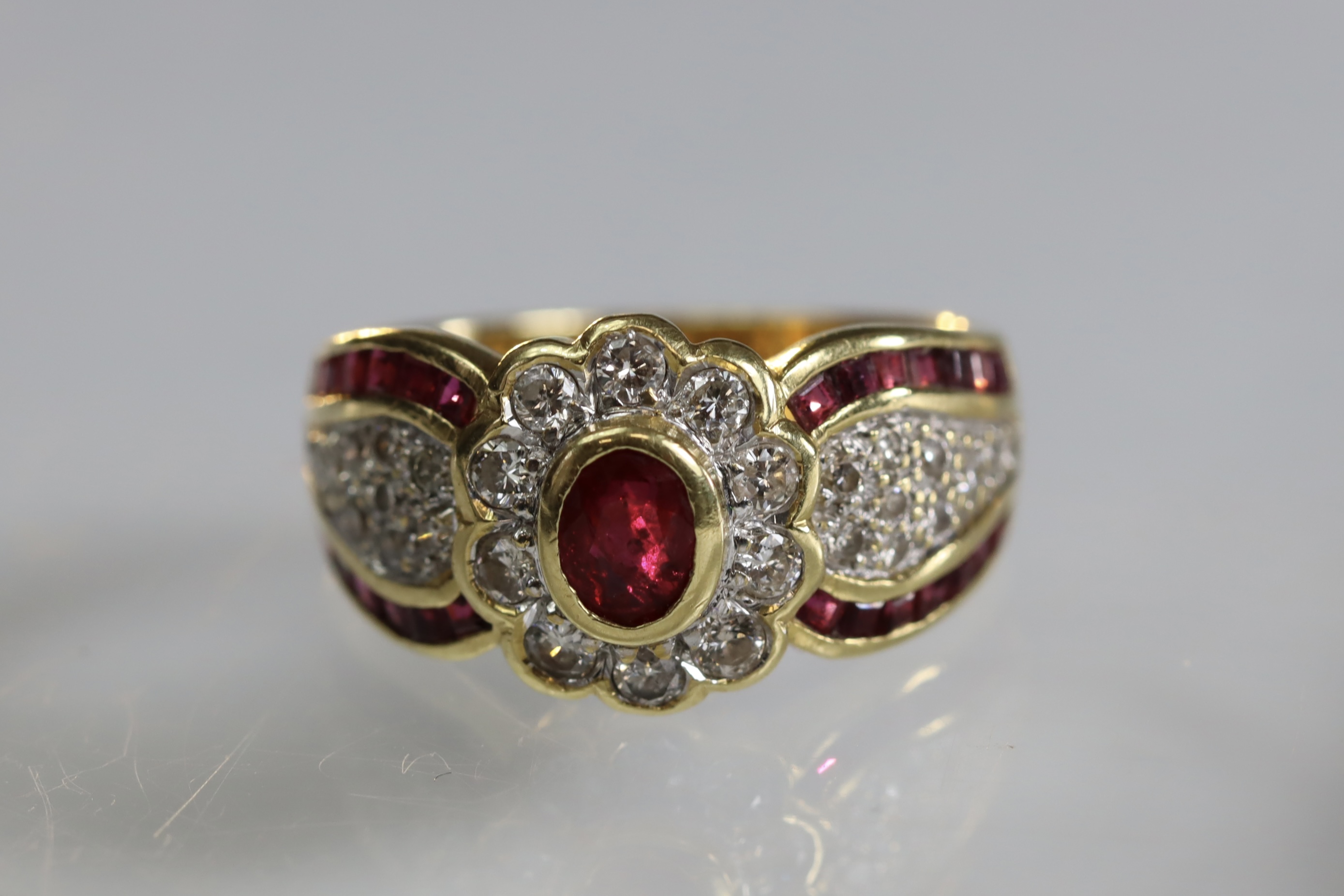 A contemporary 18 carat Yellow Gold, Ruby and Diamond Dress Ring,the oval shaped ruby central - Image 2 of 14