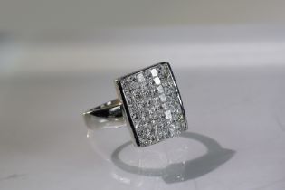 An Unusual Invisibly Set style Princess Cut Diamond Dress Ringmounted in 18 carat white gold,