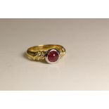 A Ruby and Diamond 18 Carat Yellow Gold Ring,Set to the centre with a circular shaped cabochon