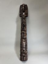A model totem pole. Northwest Coast Canada.Carved in wood with a stacked arrangement of totemic